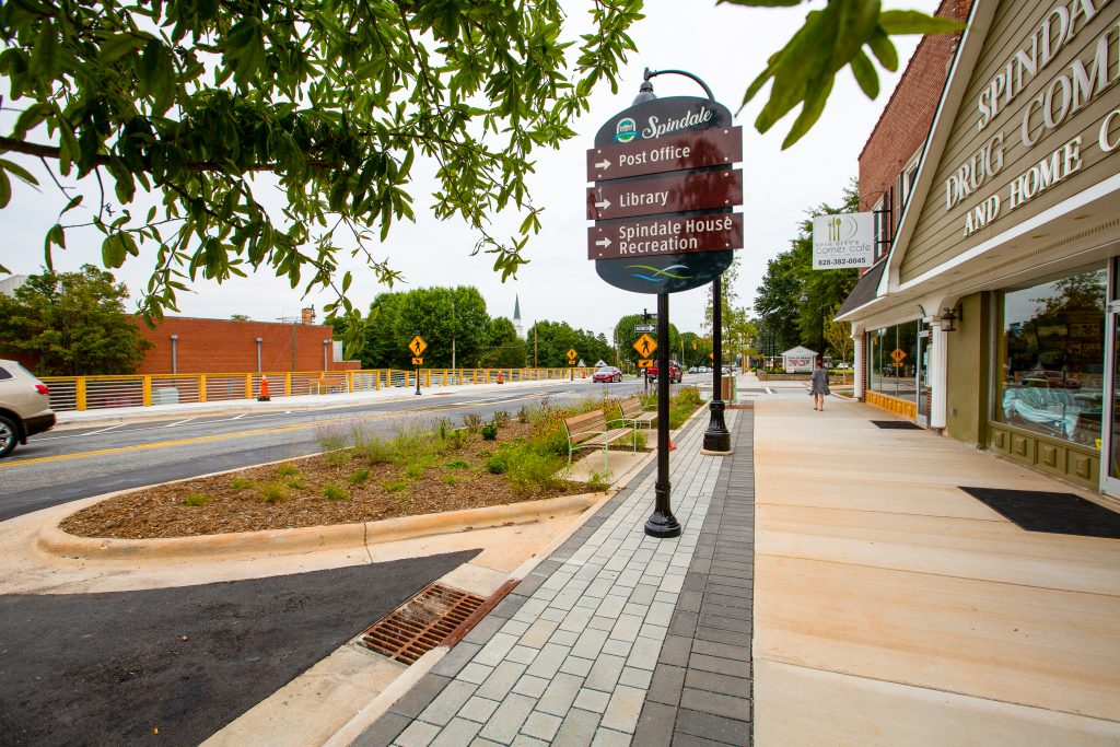A wayfinding sign in downtown Spindale directs pedestrians to various locations.
